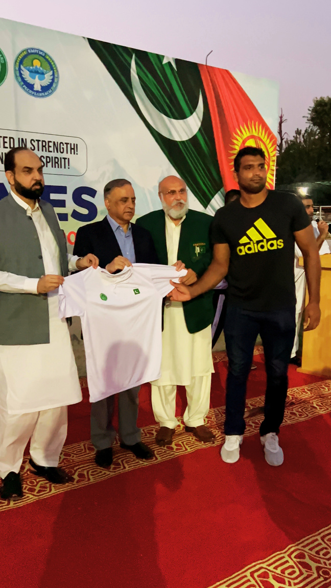 Athlete receiving official kit from officials