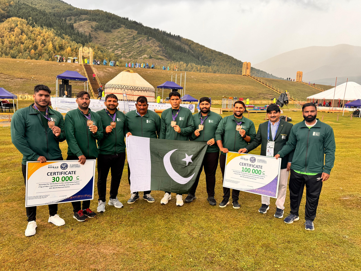 Pakistan Tug of War 8x8 team celebrating with flags